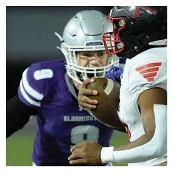 A football player wearing a blue and red jersey. Description generated by AI