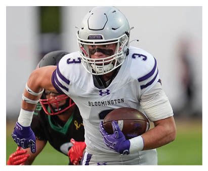 A football player wearing a blue and red jersey. Description generated by AI