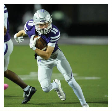 A football player wearing a blue and red jersey. Description generated by AI