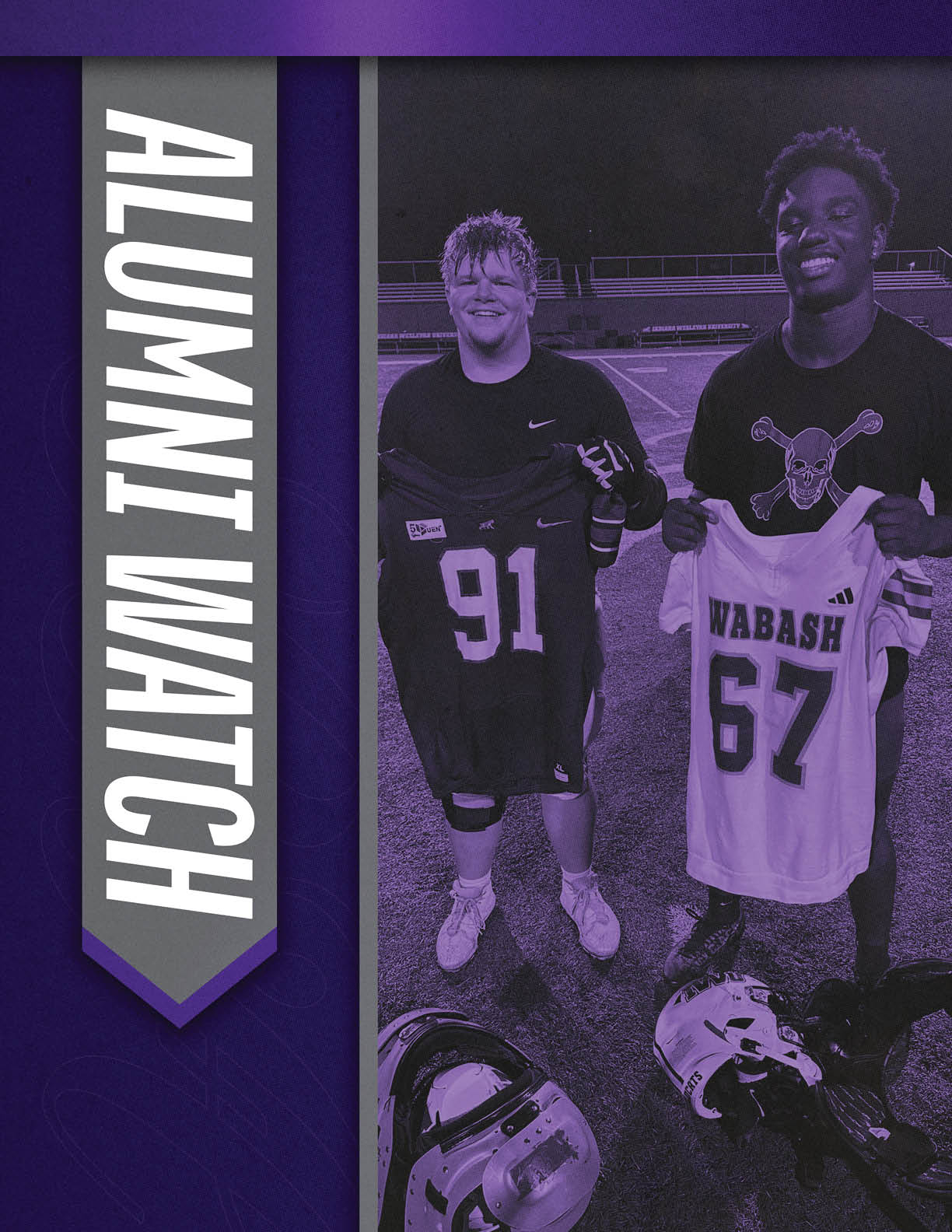Two people stand on a sports field at night holding football jerseys with helmets on the ground nearby and a vertical banner reading Alumni Watch beside them. Description generated by AI
