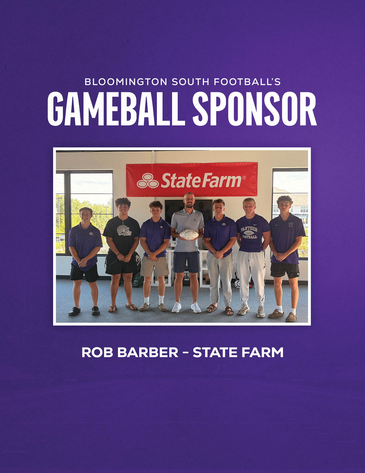 Seven people standing indoors in front of a State Farm banner with text above and below them indicating Bloomington South Football's gameball sponsor is Rob Barber from State Farm. Description generated by AI