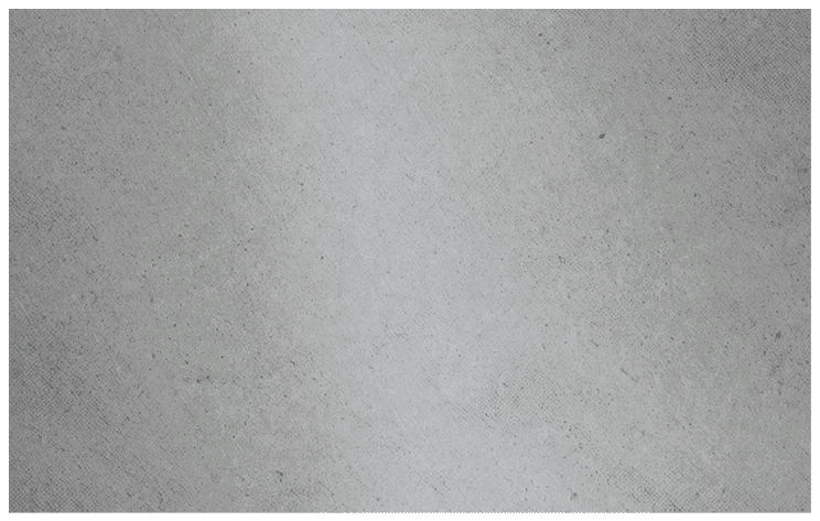 A close-up view of a textured gray fabric surface with small scattered dark specks. Description generated by AI