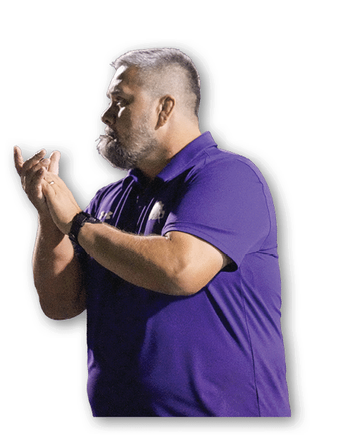 Person with short hair and beard wearing a purple polo shirt is clapping hands against a white background. Description generated by AI