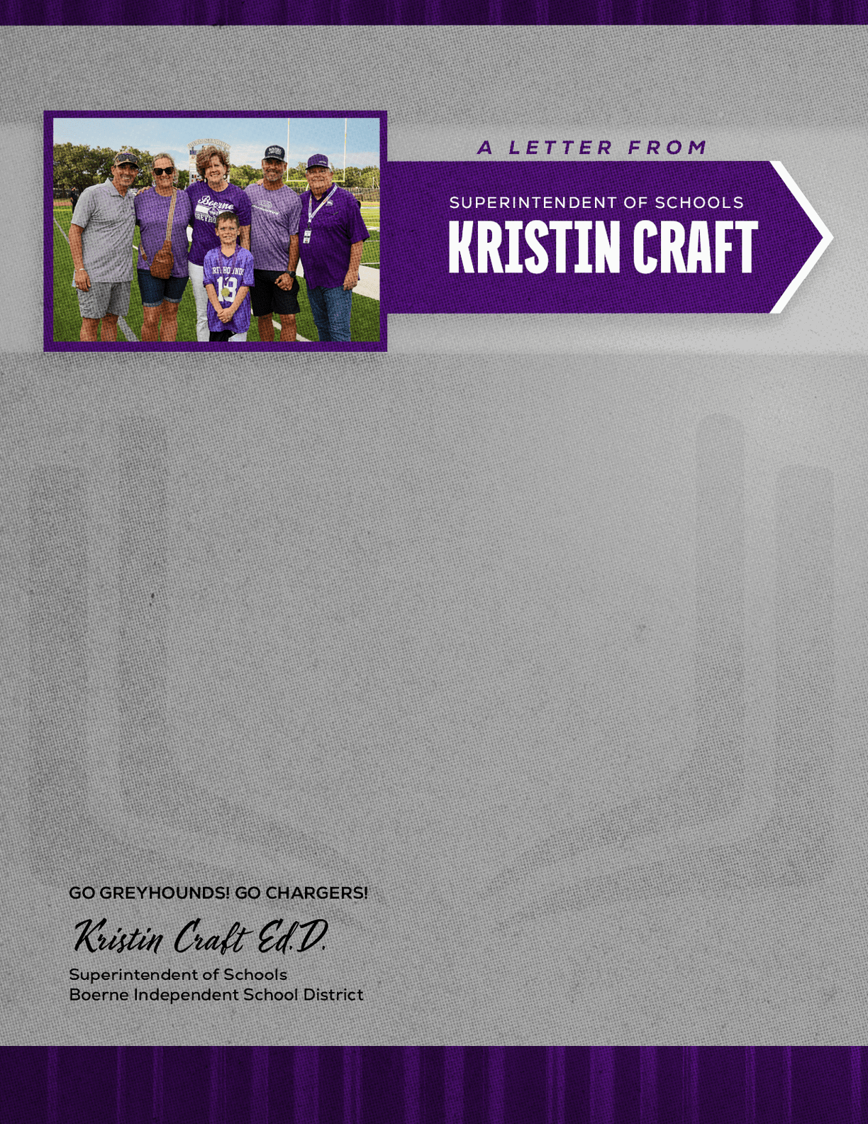 A group of six people wearing casual and sports clothing pose outdoors next to a purple banner that reads a letter from Kristin Craft, superintendent of schools. Description generated by AI
