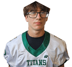A person with short brown hair and glasses is wearing a white sports jersey with green trim and the word “TITANS" on the front. Description generated by AI