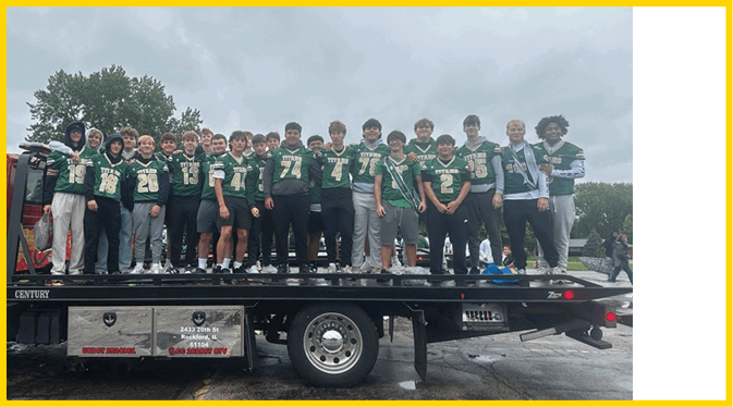 A group of people wearing green sports jerseys with the word “TITANS" and various numbers stand closely together outdoors. Description generated by AI