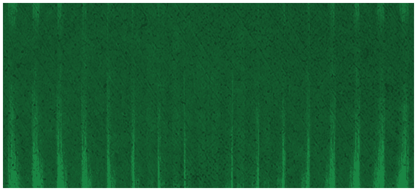 A close-up view of a textured green surface with vertical ridges and subtle shading variations. Description generated by AI