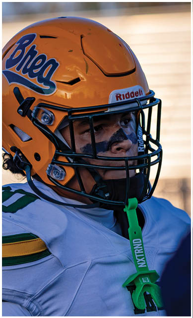 A football player wearing a blue jersey with the number 58 on it. Description generated by AI