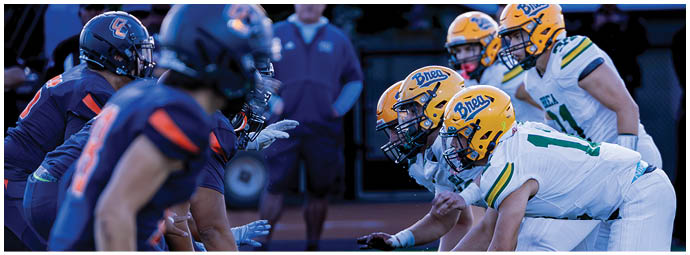 A football player wearing a blue and white uniform. Description generated by AI