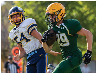 A group of football players on a field. Description generated by AI