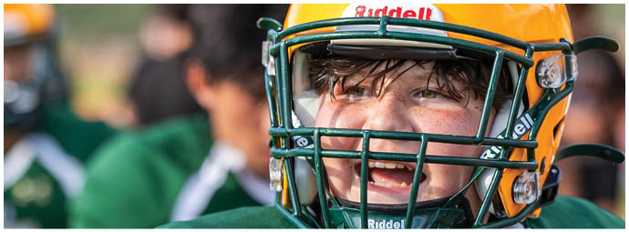 A football player wearing a blue and white uniform. Description generated by AI