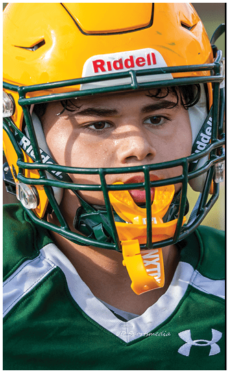 A football player catching a ball. Description generated by AI