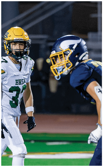 A football player catching a ball. Description generated by AI