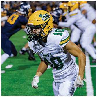 A football player running on the field. Description generated by AI