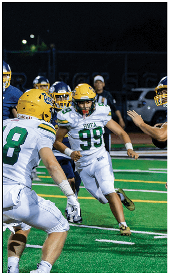 A football player catching a ball. Description generated by AI