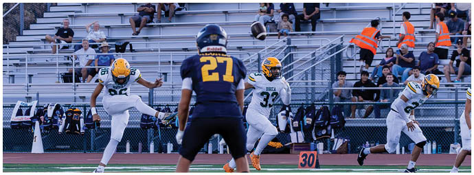 A football player is sliding on the ground. Description generated by AI