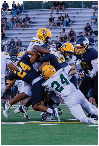 A football player running on the field. Description generated by AI