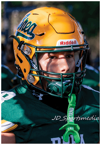 A football player wearing a blue jersey with the number 58 on it. Description generated by AI