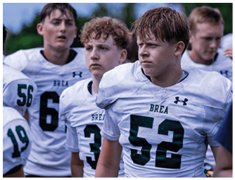 A group of football players on a field. Description generated by AI