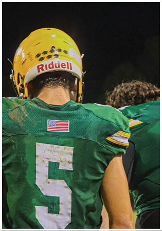 A football player wearing a blue jersey with the number 58 on it. Description generated by AI