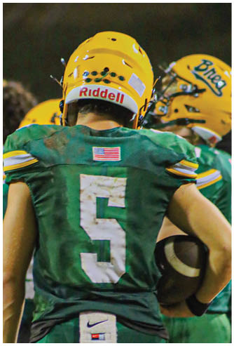 A football player running on the field. Description generated by AI