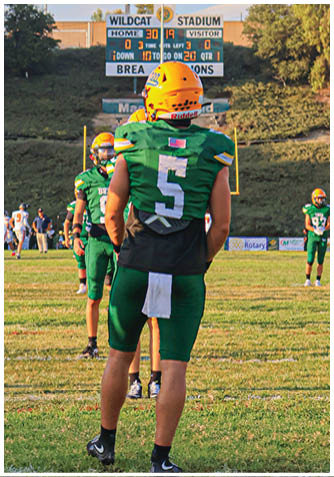 A football player wearing a blue jersey with the number 58 on it. Description generated by AI