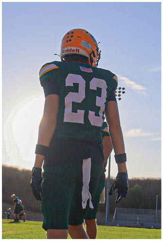 A football player running on the field. Description generated by AI