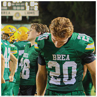 A football player running on the field. Description generated by AI