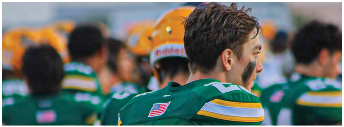 A football player is sliding on the ground. Description generated by AI