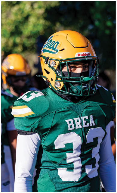 A football player wearing a blue jersey with the number 58 on it. Description generated by AI