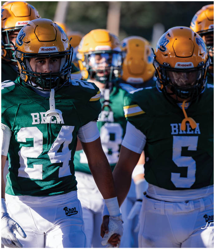 A group of football players wearing black and white uniforms. Description generated by AI