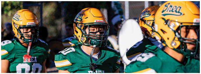 A football player is sliding on the ground. Description generated by AI