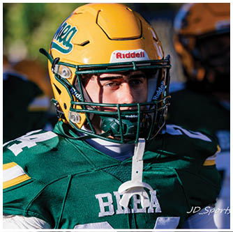 A football player running on the field. Description generated by AI