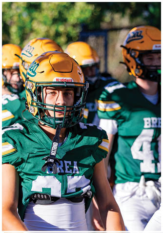 A football player wearing a blue jersey with the number 58 on it. Description generated by AI