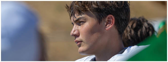 A football player wearing a blue and white uniform. Description generated by AI