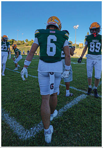 A football player wearing a blue jersey with the number 58 on it. Description generated by AI