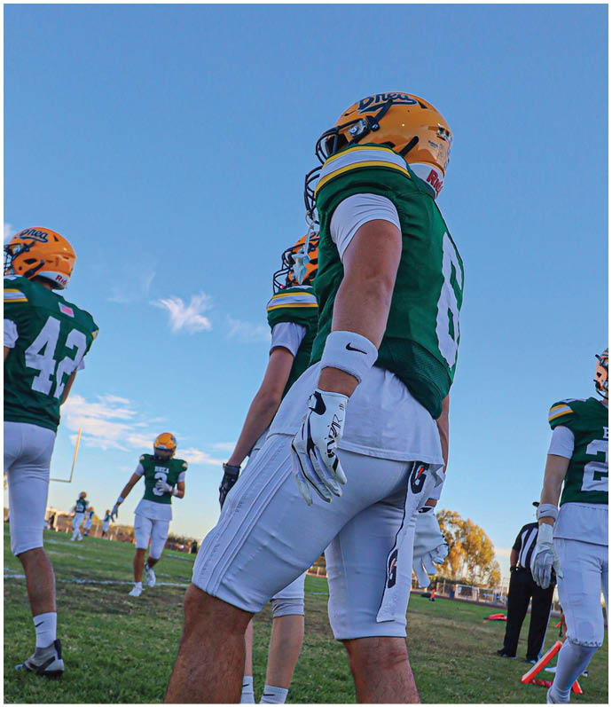 A group of football players wearing black and white uniforms. Description generated by AI