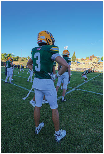 A football player running on the field. Description generated by AI