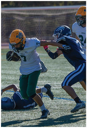 A football game is being played on a field. Description generated by AI