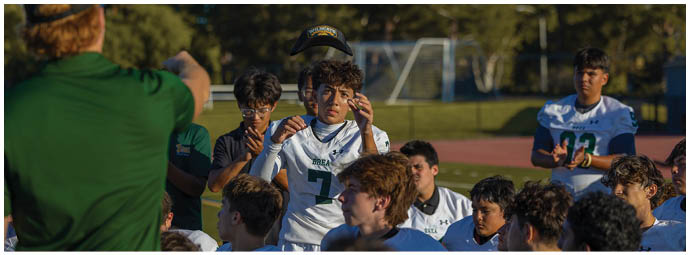 A football player wearing a blue and white uniform. Description generated by AI