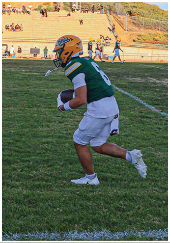 A football player wearing a blue jersey with the number 58 on it. Description generated by AI