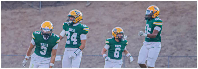 A group of football players on a field. Description generated by AI