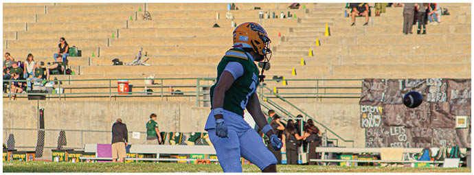 A football player is sliding on the ground. Description generated by AI
