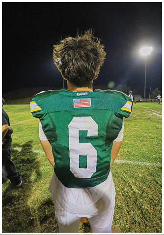 A football player wearing a blue jersey with the number 58 on it. Description generated by AI