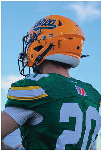 A football player running on the field. Description generated by AI