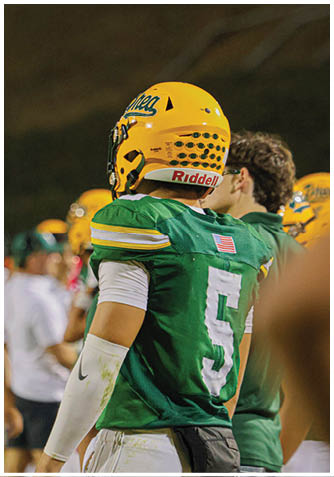 A football player wearing a blue jersey with the number 58 on it. Description generated by AI