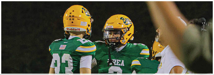 A group of football players on a field. Description generated by AI