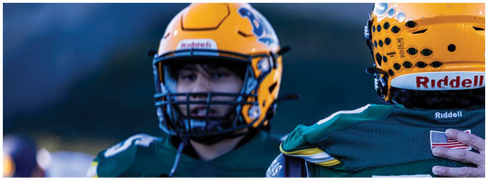 A football player is sliding on the ground. Description generated by AI
