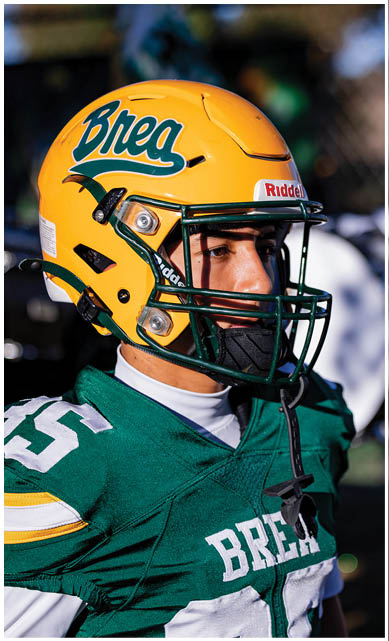 A football player wearing a blue jersey with the number 58 on it. Description generated by AI