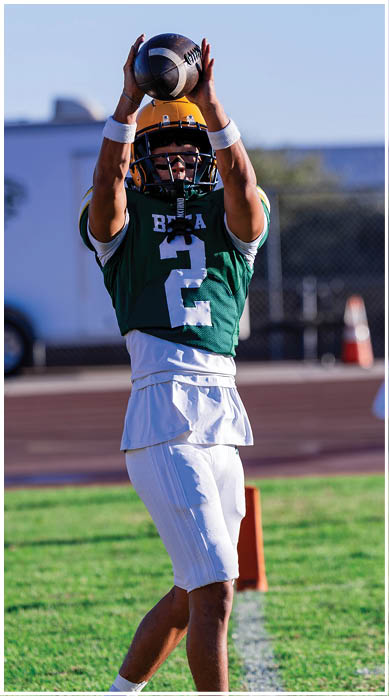 A football player running on the field. Description generated by AI